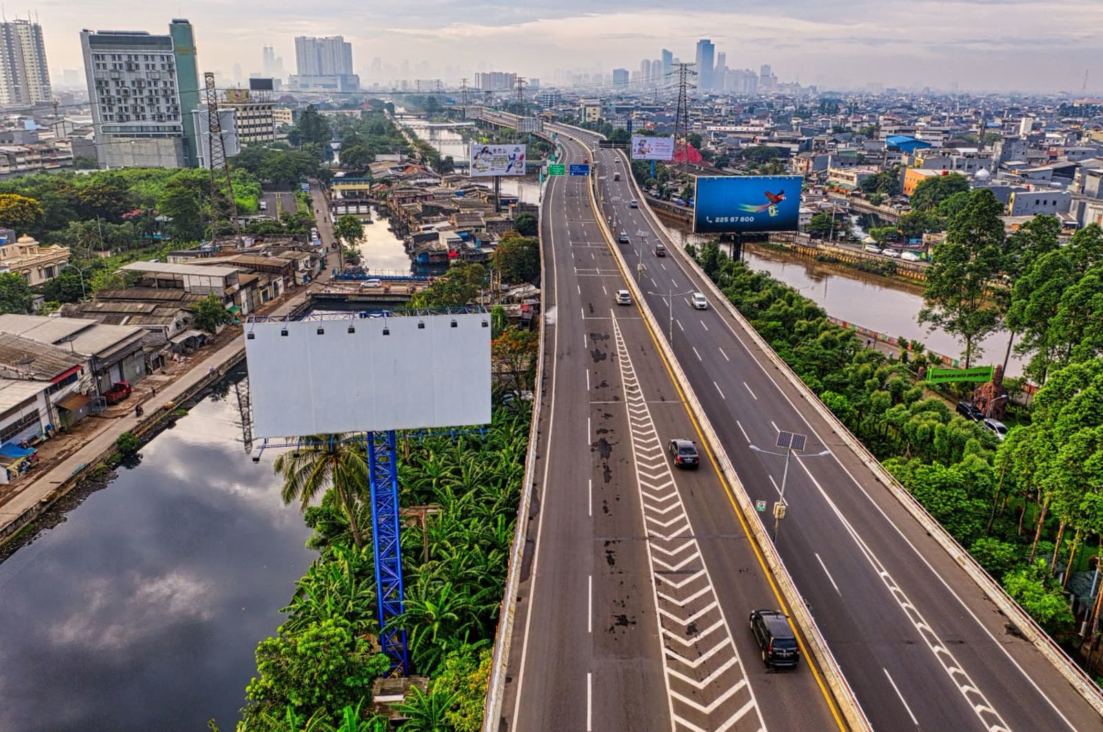 An expressway billboard against the city skyline.